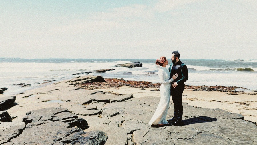 Wedding couple on coastal rocks in Ireland